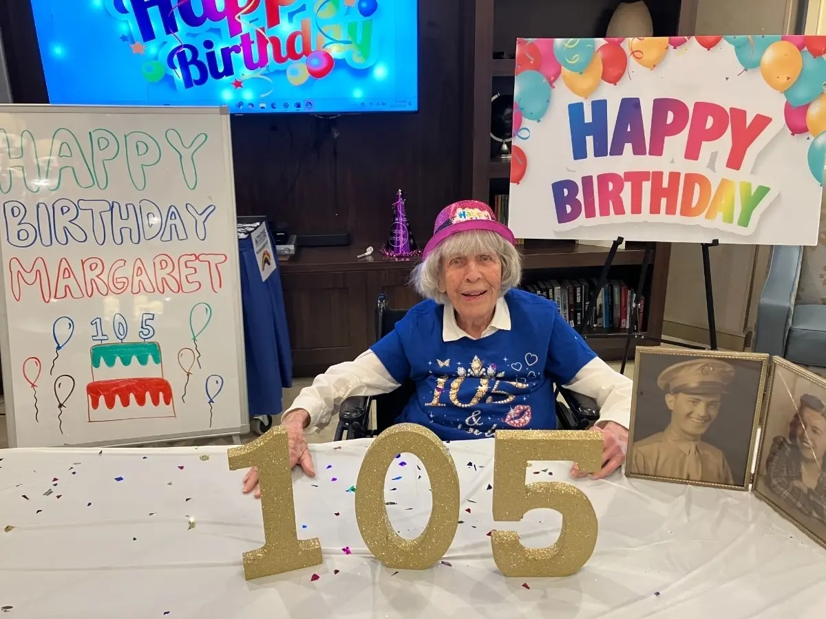 Margaret, CareOne at Somerset Resident, sits at a table decorated for her 105th birthday